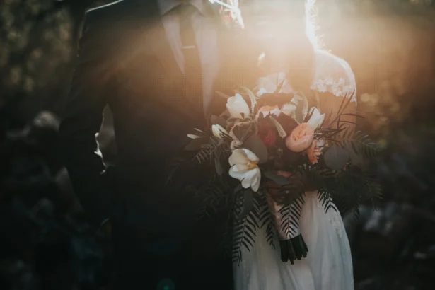 A wedding couple with a sun setting in the background.