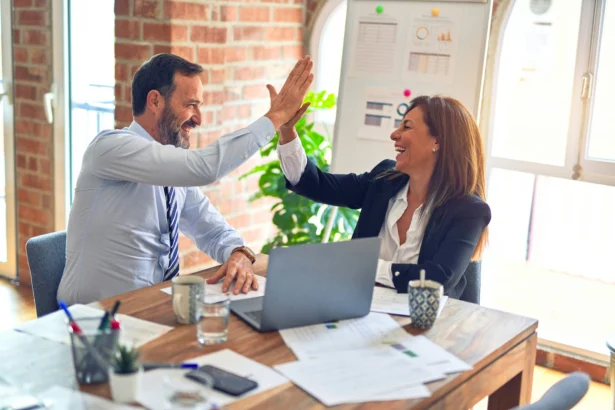 Two small business owners high fiving