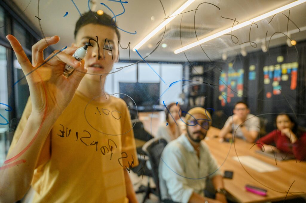 Man Writing with Magic Marker During Business Meeting