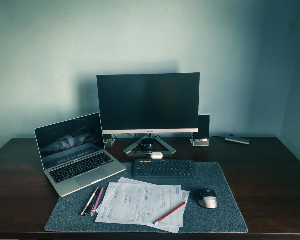 A PC and Laptop Setup in a Workspace